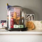 Collection of objects from vacations and travel with glass dome